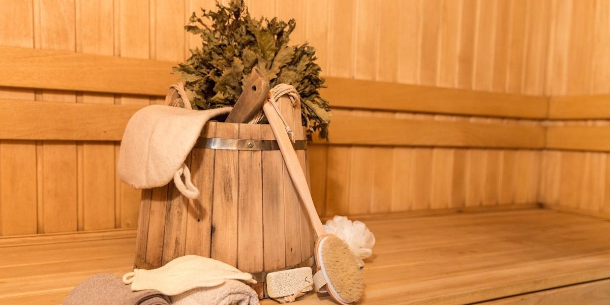 Holzeimer, Handtücher Eimer und Bürste stehen im inneren einer Sauna